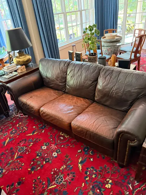 Faded leather sofa seat cushions before recoloring in Denver