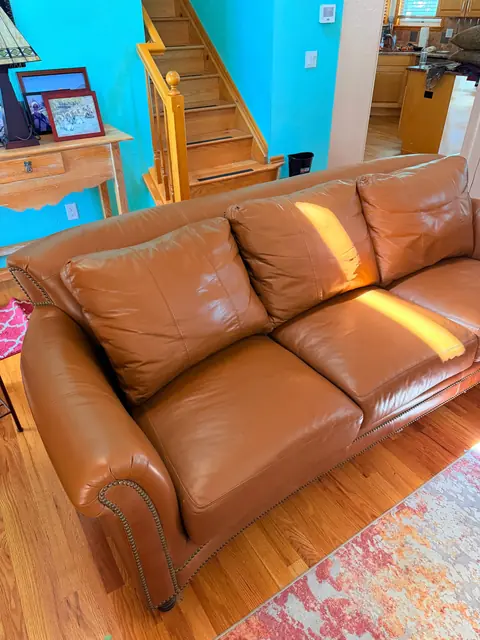 Brown leather sofa after professional restoration in Denver Metro