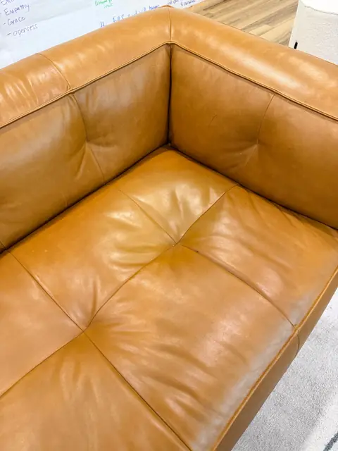 Tan leather sofa cushion after stain removal and refinishing in Denver