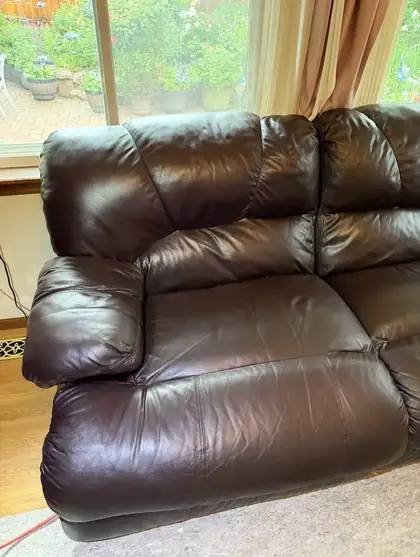 Leather recliner armrest after crack and burn repair in Denver