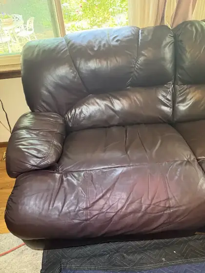 Cracked leather recliner armrest before repair in Denver
